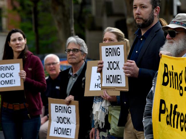 Supporters are seen holding placards during a rally to free Jock Palfreeman at Sydney Town Hall in Sydney. Picture: AAP