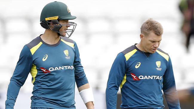 A clean shaven David Warner with Tim Paine.