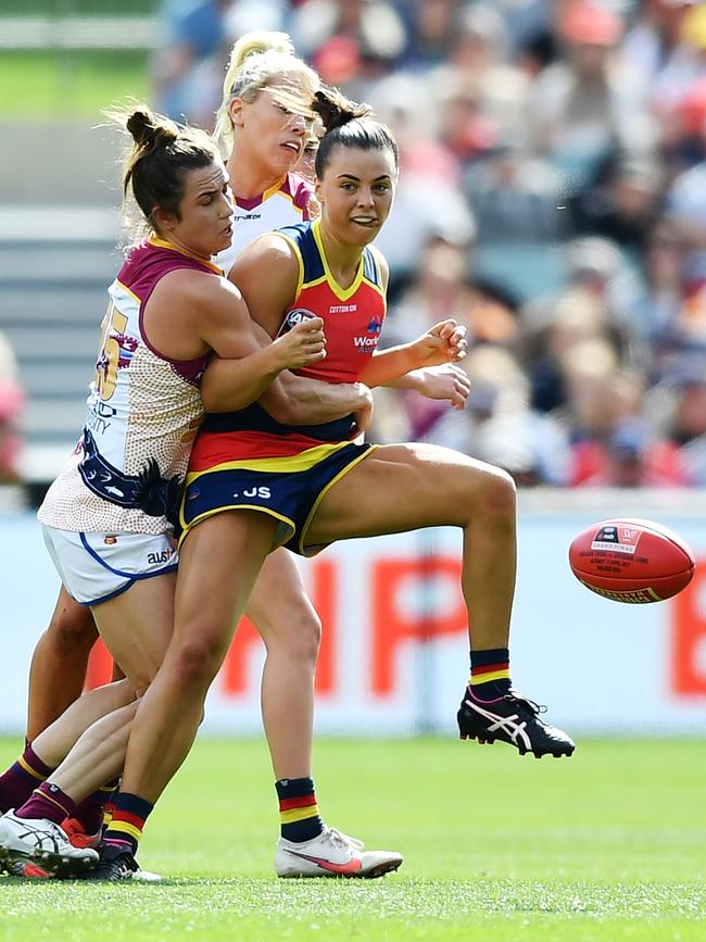 Marinoff gets a kick away during the 2021 AFLW grand final at Adelaide Oval under intense pressure from Brisbane’s Catherine Svarc. Picture: Mark Brake / Getty