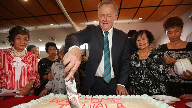 Anthony Albanese cuts a cake welcoming ‘Albo’ to Inala with 103-year-old No Luu at a Vietnamese seniors event on Tuesday in Inala, Brisbane. Picture: Lyndon Mechielsen