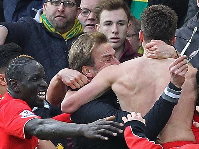 With his shirt off, Liverpool's English midfielder Adam Lallana celebrates as Jurgen Klopp loses his glasses.