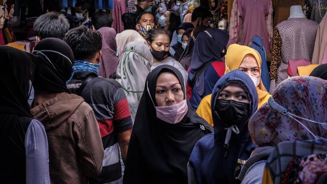 Indonesians crowd a traditional textile market in Jakarta to buy clothes before the Eid holiday. Picture: Getty Images