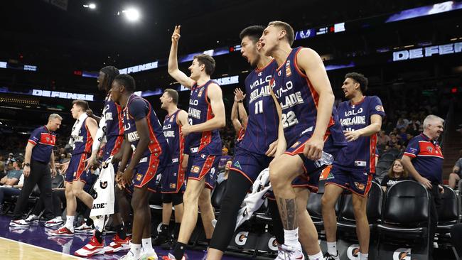 PHOENIX, ARIZONA - OCTOBER 02: Cameron Thew #13, Kai Sotto #11 and Hyrum Harris #22 of the Adelaide 36ers react after a basket during the second half against the Phoenix Suns at Footprint Center on October 02, 2022 in Phoenix, Arizona. The 36ers beat the Suns 134-124. NOTE TO USER: User expressly acknowledges and agrees that, by downloading and or using this photograph, User is consenting to the terms and conditions of the Getty Images License Agreement.   Chris Coduto/Getty Images/AFP