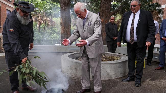 The King participates in a traditional smoking ceremony conducted by community representatives from the Gadigal people of the Eora Nation during a visit to the National Centre of Indigenous Excellence in Redfern. Picture: Lisa Maree Williams/Getty Images