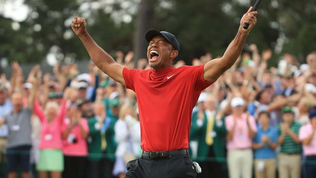 Woods celebrates his 15th and most recent major triumph, the 2019 Masters, in his trademark Nike red. Picture: Getty Images