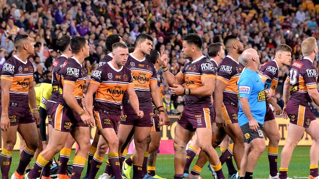 The Broncos players look dejected after a try is scored against them