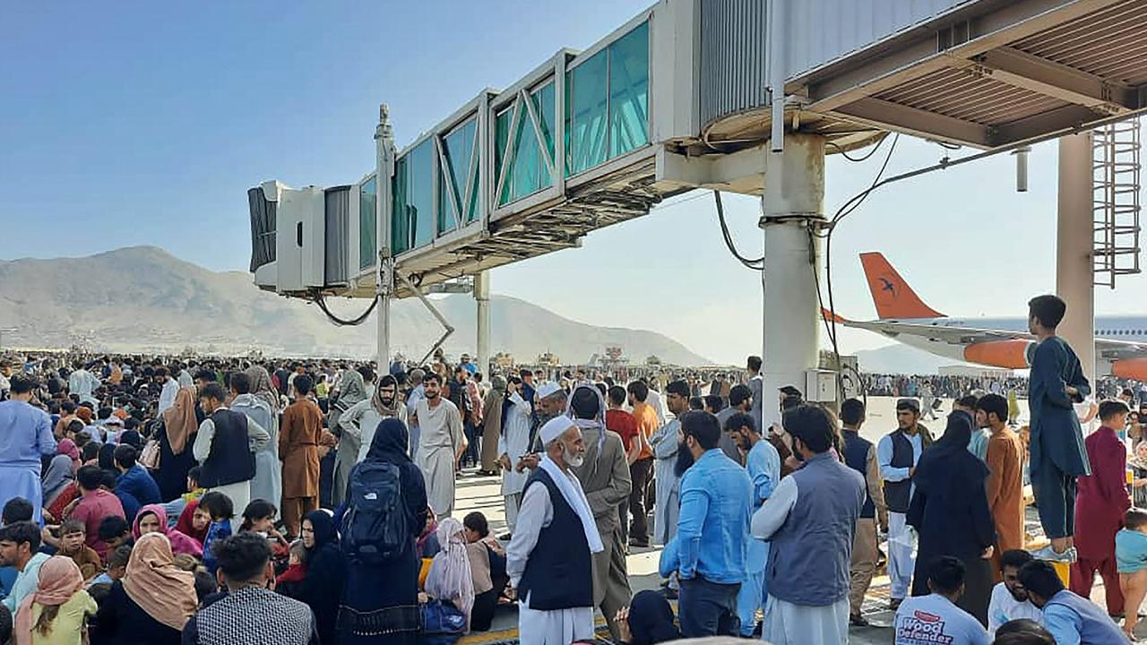 Afghans crowd at the tarmac on August 16. Picture: AFP