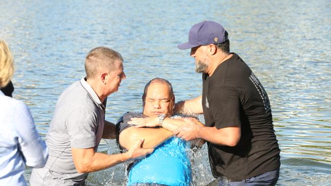 Tom Tate getting baptised at Evandale Lake. Picture: Mike Batterham