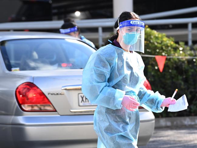 An SA Health worker conducting Covid tests at Tea Tree Medical Center in Modbury, where there are big line-ups after the case was revealed. Picture: Keryn Stevens