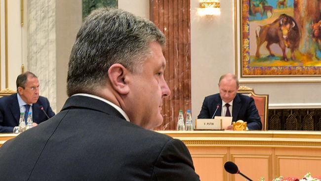 Ukrainian president Petro Poroshenko faces Russian president Vladimir Putin (R) and Russian Foreign Affairs minister Serguei Lavrov. Picture: Mykola Lazarenko