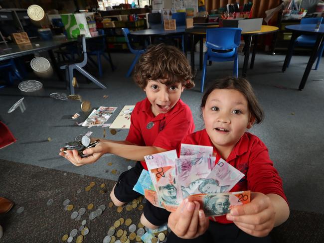 At Richmond Primary School, young students are learning about cash using coins and notes. Jordy Tregambe, 6, and Mai Coutts, 6, in grade 1 using the cash to learn about the importance of money. Picture: Alex Coppel