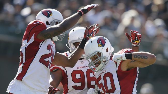 Larry Foote with teammates Kareem Martin and Jerraud Powers after sacking Derek Carr.