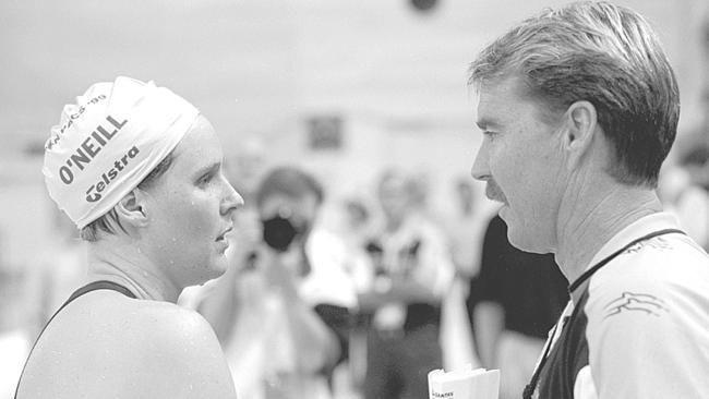 Susie O'Neill speaks with her coach Scott Volkers at the Pan Pacific Championships in 1999. Picture: Adam Pretty