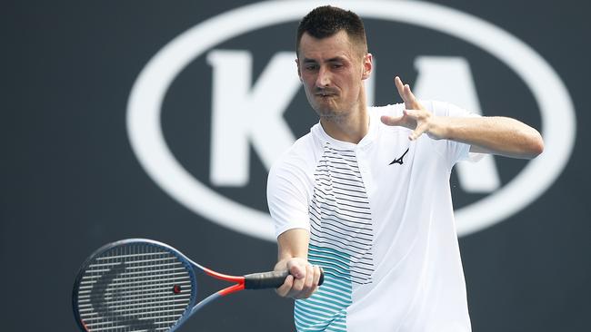 Bernard Tomic plays a forehand in his match against Denis Kudla.