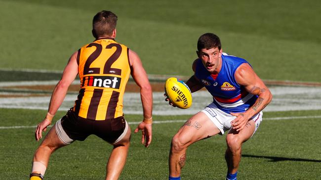 Bulldog Tom Liberatore evades Hawk Luke Breust at Adelaide Oval in September. Picture: Matt Turner/Getty Images)