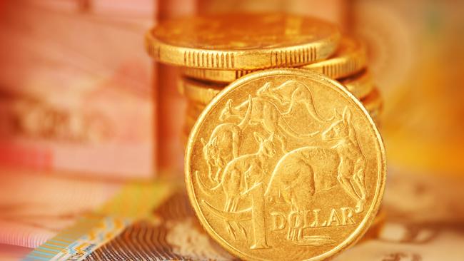 Australian Dollar Coin. Note this is a circulated coin so has some nicks and scratches. Stock image of a pile of Australian dollars with Australian money in background generic