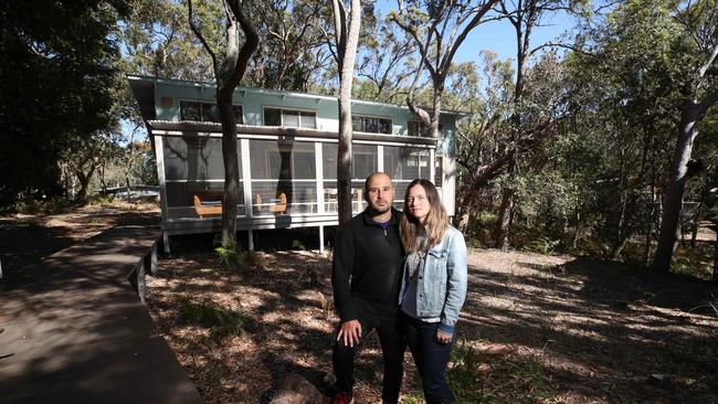 South Stradbroke Island Eco cabins has had a long saga of issues that have plagued the island’s residents. Sara Skipworth and Eudes Zavarc in front of their cabin. Picture: Glenn Hampson