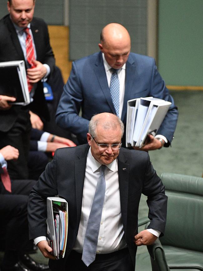 Minister for Home Affairs Peter Dutton, top, and Prime Minister Scott Morrison leave Question Time yesterday.