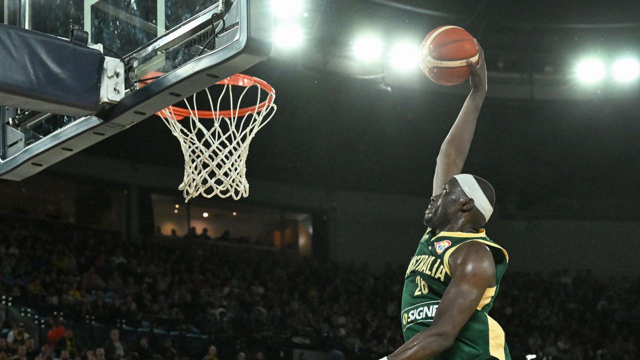 Australia's Duop Reath dunks during the international friendly basketball match between Australia and Venezuela, in Melbourne on August 14, 2023, in preparation for the 2023 Philippines-Japan-Indonesia FIBA Basketball World Cup. (Photo by William WEST / AFP) / —IMAGE RESTRICTED TO EDITORIAL USE – STRICTLY NO COMMERCIAL USE–