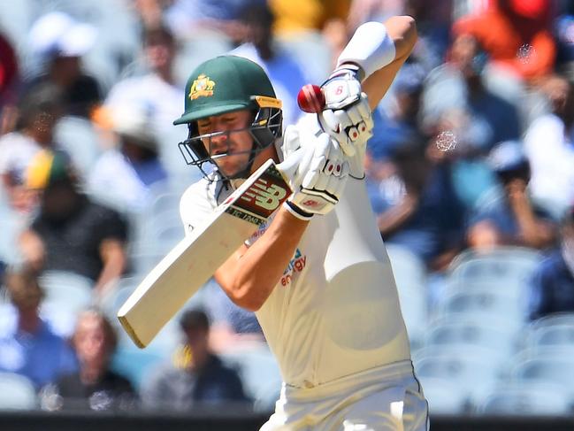 Australia's Pat Cummins fends the ball off with his glove and is caught on the fourth day of the second cricket Test match between Australia and India at the MCG in Melbourne on December 29, 2020. (Photo by WILLIAM WEST / AFP) / --IMAGE RESTRICTED TO EDITORIAL USE - STRICTLY NO COMMERCIAL USE--