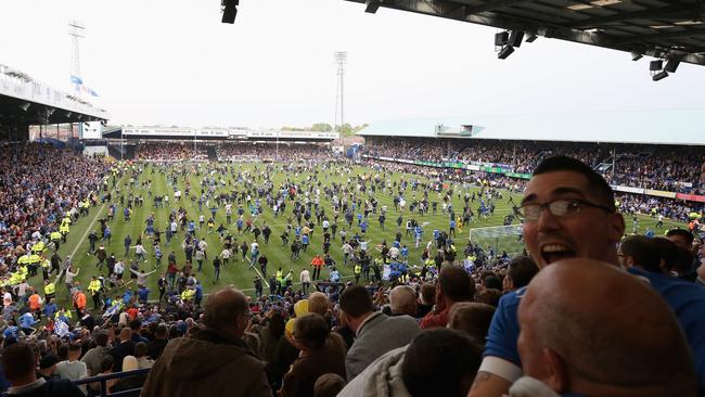 Portsmouth fans run onto the pitch.