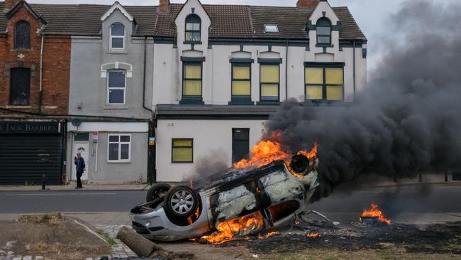 A car burns after it was set on fire during a demonstration in Middlesbrough. Picture: Getty Images