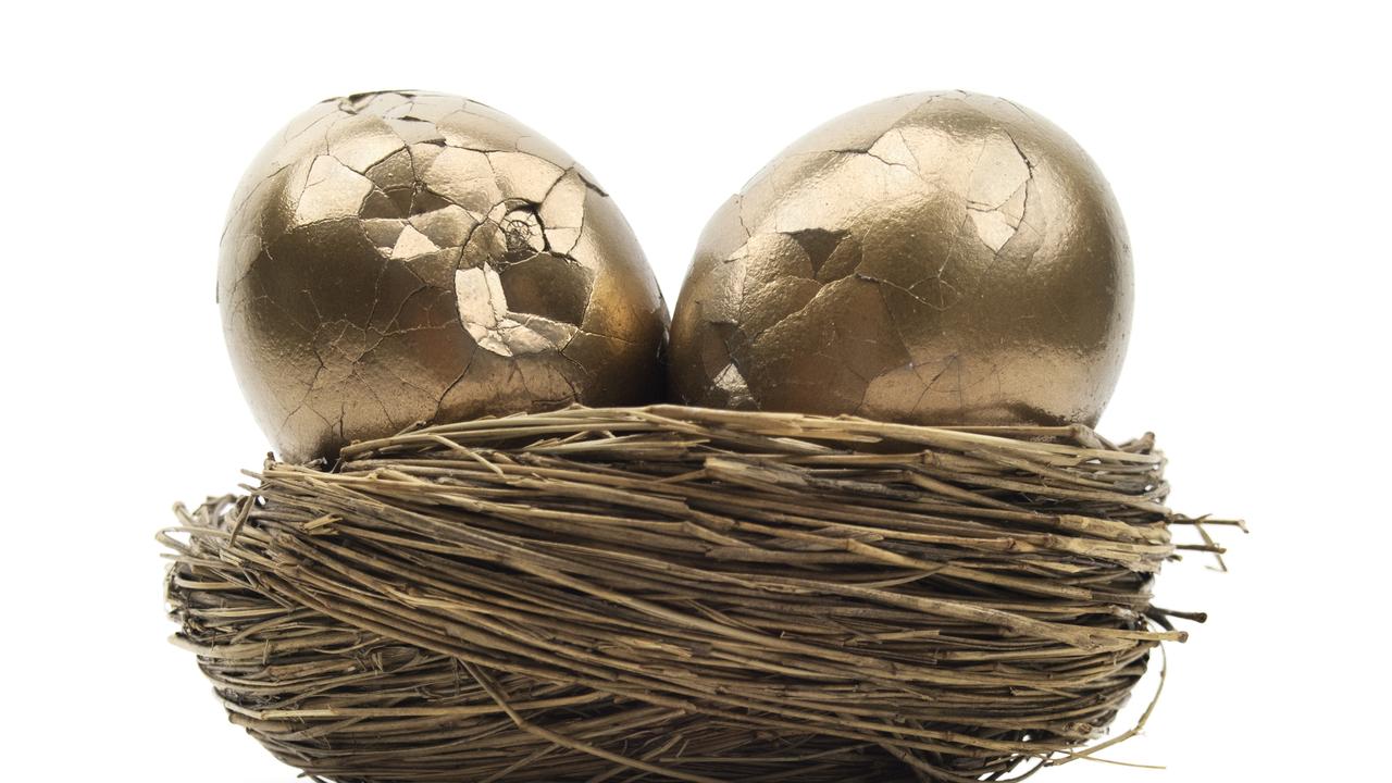 Isolated broken golden eggs in nest egg, superannuation cracked generic