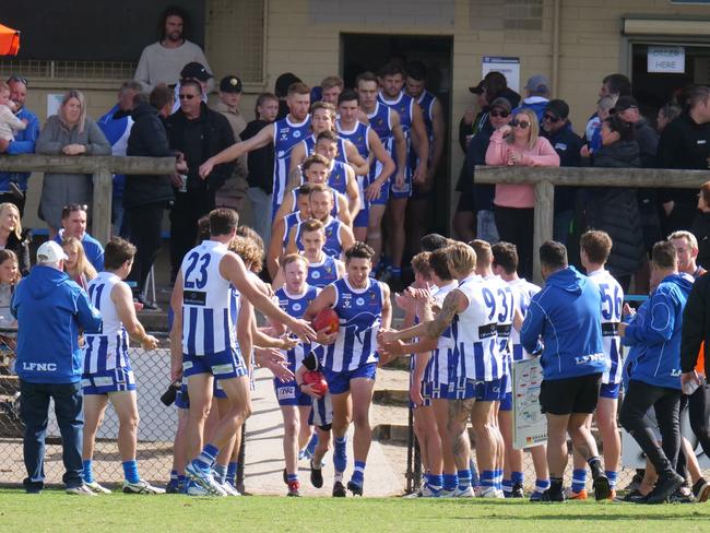 Mark Baguley leads Langwarrin on to the ground in his 100th game. Picture: Paul Churcher