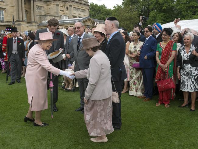 Queen Elizabeth II talks to guests during a garden party at Buckingham Palace on May 16, 2017 in London, England. Picture: Getty