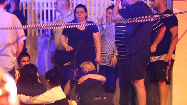 Two women cry at the intersection. Picture: Wayne Taylor