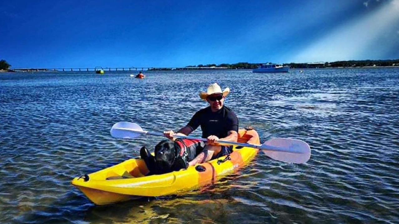 Michael Cooper was the first person in Australia to receive NDIS funding for his guide dog, Cody, seen here kayaking.