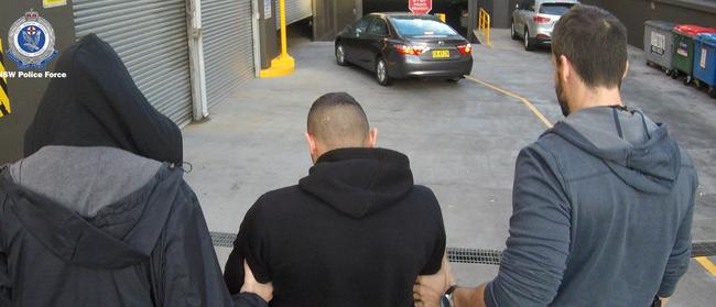 The man is being led into the police station. Picture: NSW Police