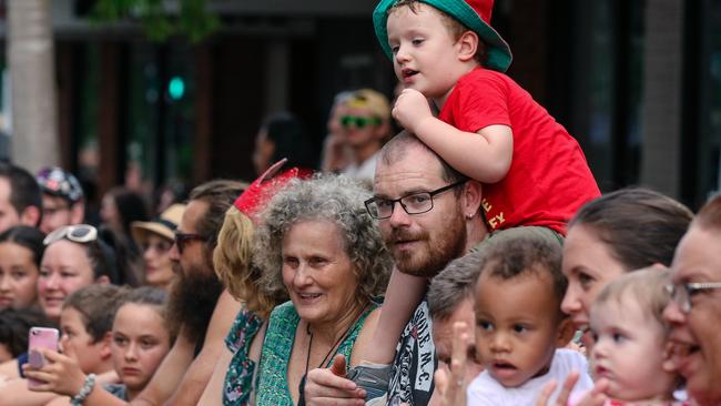 Dean Wilson and son Oscar as crowds line the route for the annual Christmas Pageant and Parade down the Esplanade and Knuckey Streets. Picture: Glenn Campbell