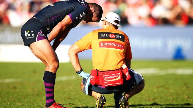 Storm skipper Cameron Smith receives attention from the trainer.