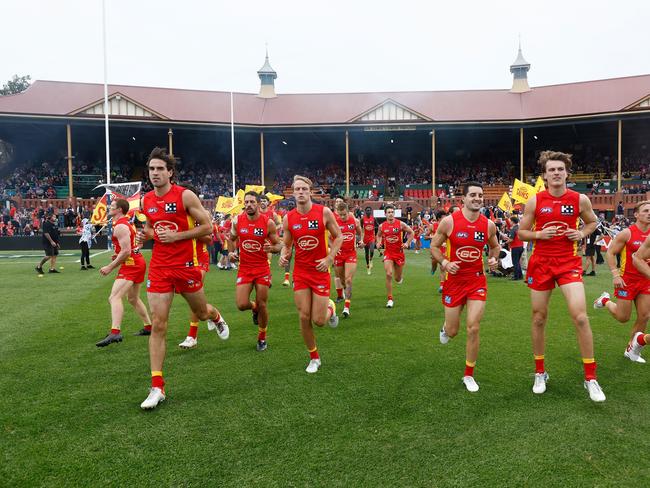 ADELAIDE, AUSTRALIA - APRIL 14: The Suns run onto the field during the 2023 AFL Round 05 match between the Fremantle Dockers and the Gold Coast Suns at Norwood Oval on April 14, 2023 in Adelaide, Australia. (Photo by Michael Willson/AFL Photos via Getty Images)