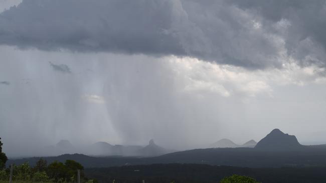 Storm clouds gather over the Glass House Mountains.