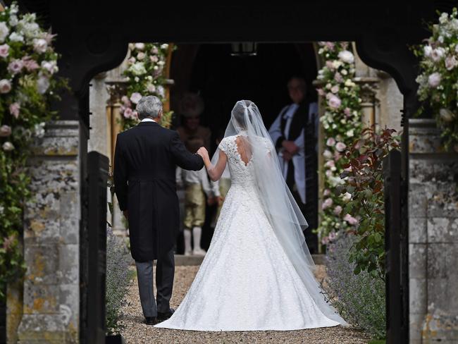 Here comes the bride ... Pippa walks into the church with her father.