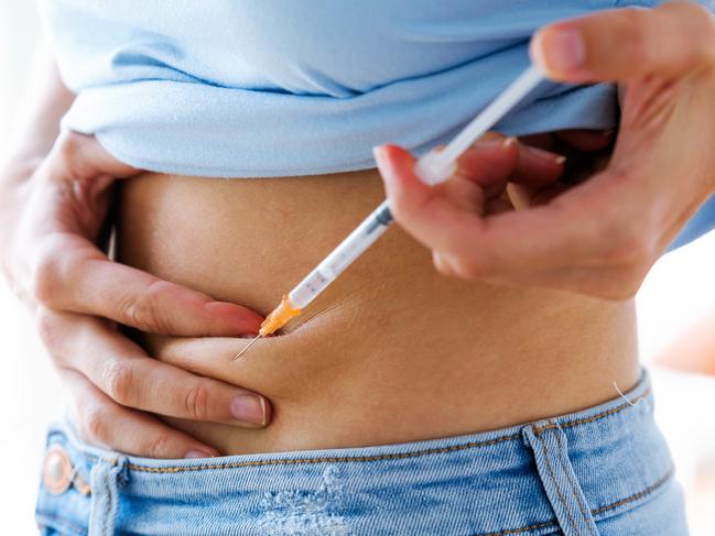 Close-up of female diabetes patient making subcutaneous insulin injection into her abdomen. Diabetes, health care and medical concept. injecting injection woman istock