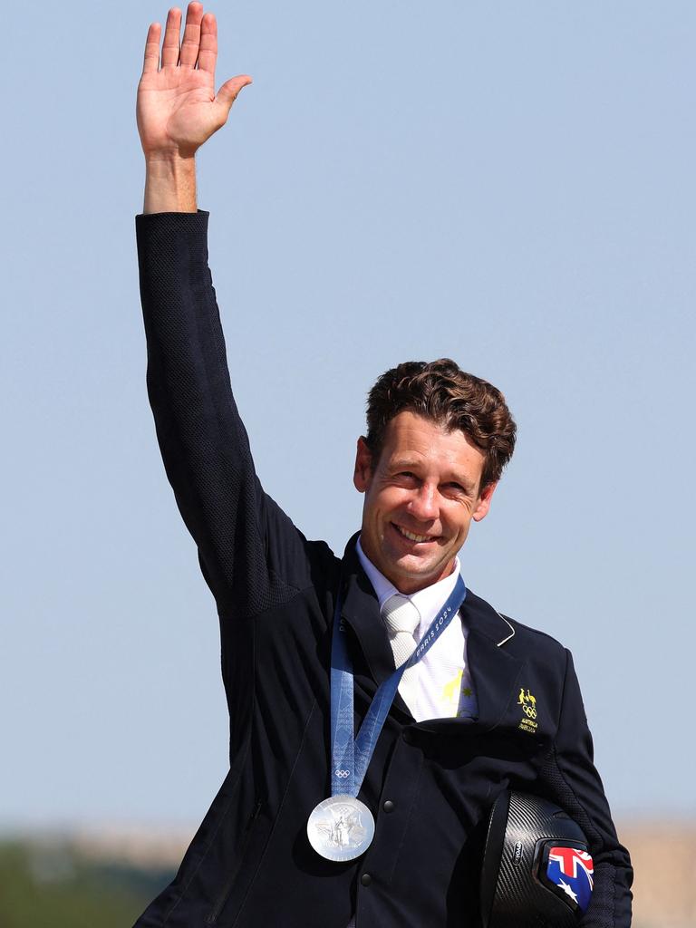 Australia's Christopher Burton celebrates his silver medal on the podium during the victory ceremony of the equestrian individual jumping at the Chateau de Versailles on July 29, 2024, during the Paris 2024 Olympic Games. (Photo by Pierre-Philippe MARCOU / AFP)