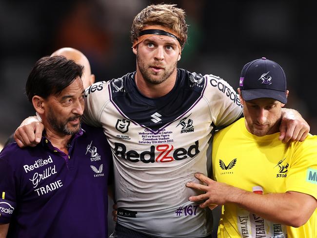 SYDNEY, AUSTRALIA - MARCH 12:  Christian Welch of the Storm is helped from the field during the round one NRL match between the Wests Tigers and the Melbourne Storm at CommBank Stadium, on March 12, 2022, in Sydney, Australia. (Photo by Mark Kolbe/Getty Images)