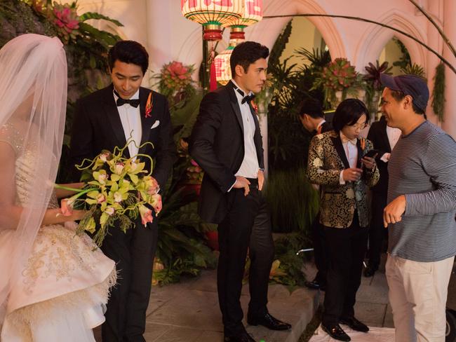 Pang (second from left) on the set of Crazy Rich Asians as Colin with (from left) Sonoya Mizuno as his bride to be, Henry Golding as best man Nick, Jimmy O. Yang as Bernard and director Jon M. Chu. Picture: Warner Bros