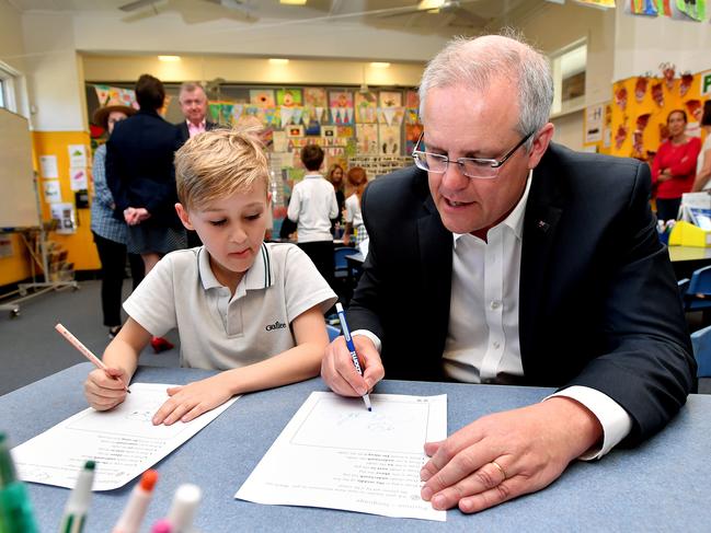 Prime Minister Scott Morrison interacts with a student during a visit to Galilee Catholic Primary School in Sydney, Friday, September 21, 2018. Prime Minister Scott Morrison has struck a $4.6 billion peace deal with Catholic and independent schools, which over a decade he says will bring to an end a long-running war over the Gonski 2.0 school funding model. (AAP Image/Joel Carrett) NO ARCHIVING