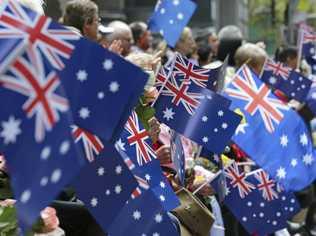 People wave flags as an ANZAC Day parade marches by in Sydney, Australia, Saturday, April 25, 2015. The ANZAC Day memorial Saturday marks the 100th anniversary of the 1915 Gallipoli landings, the first major military action fought by the Australian and New Zealand Army Corps during World War I. (AP Photo/Rob Griffith). Picture: Rob Griffith