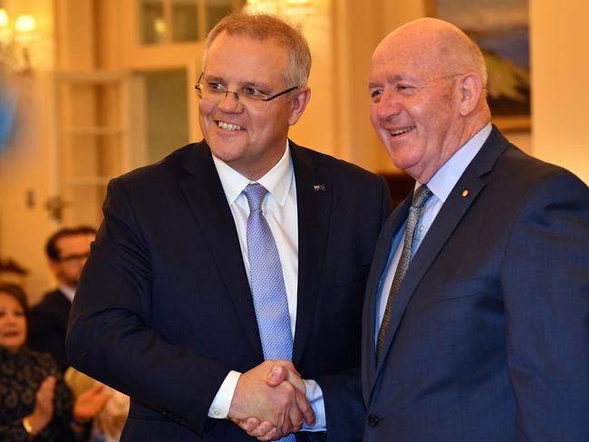 Australia's Governor General Peter Cosgrove congratulates new Scott Morrison (L) after the latter was sworn in as PM. Picture: Saeed Khan/ AFP