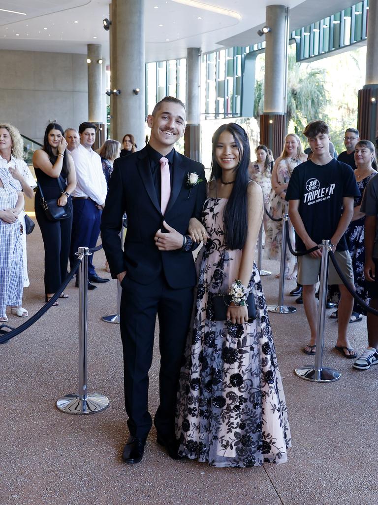 Melody Neal arrives at the Peace Lutheran College formal evening at the Cairns Convention Centre with her date Hunter Smith. Ms Neal was the victim of a stabbing at the school on May 16, which damaged her liver and severed nerves in her spine. Picture: Brendan Radke