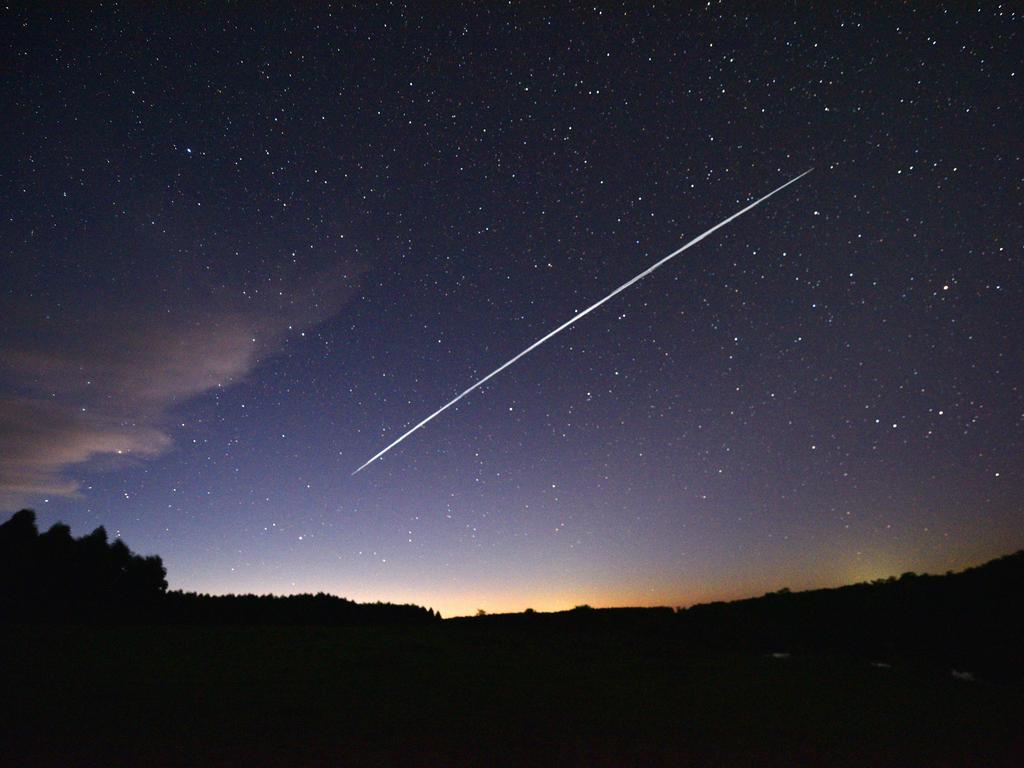 This long-exposure image shows a trail of a group of SpaceX's Starlink satellites which have irked Russia’s space boss. Picture: Mariana Suarez / AFP