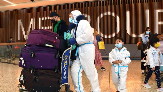 International travellers wearing PPE arrive at Melbourne's Tullamarine Airport on November 29.