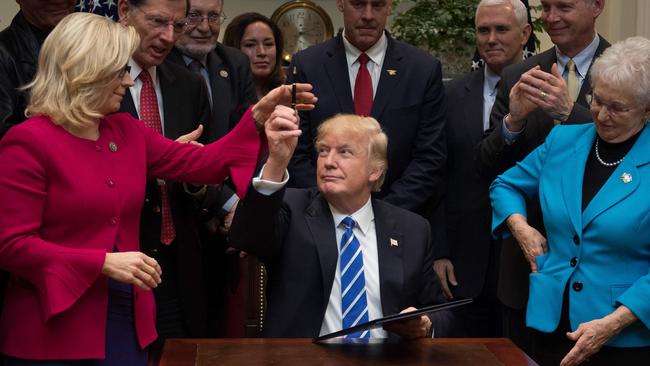 Then US President Donald Trump gives a pen to US Congresswoman Liz Cheney, at the White House in Washington, DC, in 2017. Picture: AFP