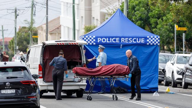 Contractors removed the body from the Tamarama street on Sunday. Picture: Max Mason-Hubers