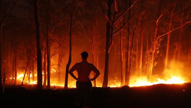 A local surveys the remains of the fire on the road to Wytaliba, the day after a fierce bush fire claimed the lives of two people in the area. Picture: Lyndon Mechielsen